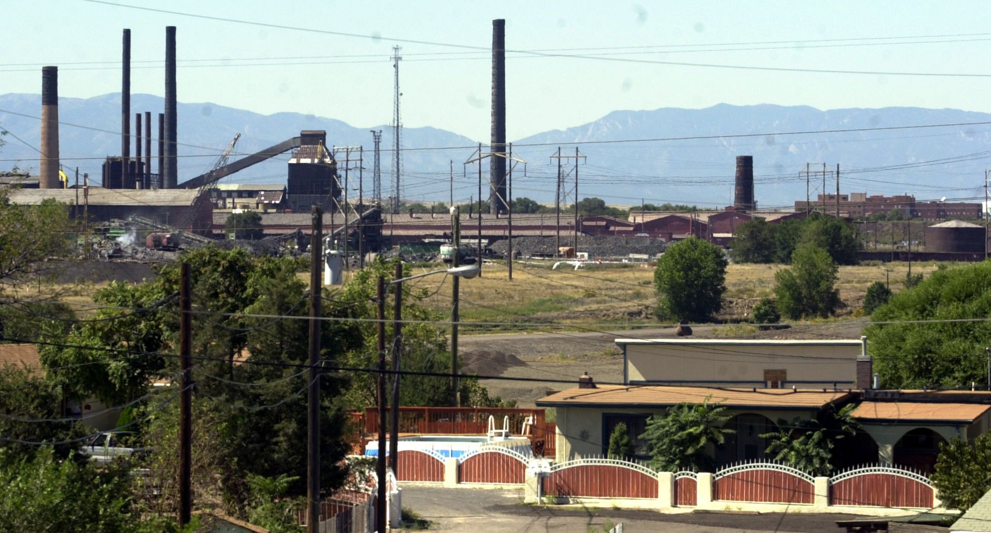 PHoto by Jerilee Bennett-Tuesday, September 26, 2000-Rocky Mountain Steel Mill looms behind an old Pueblo neighborhood.